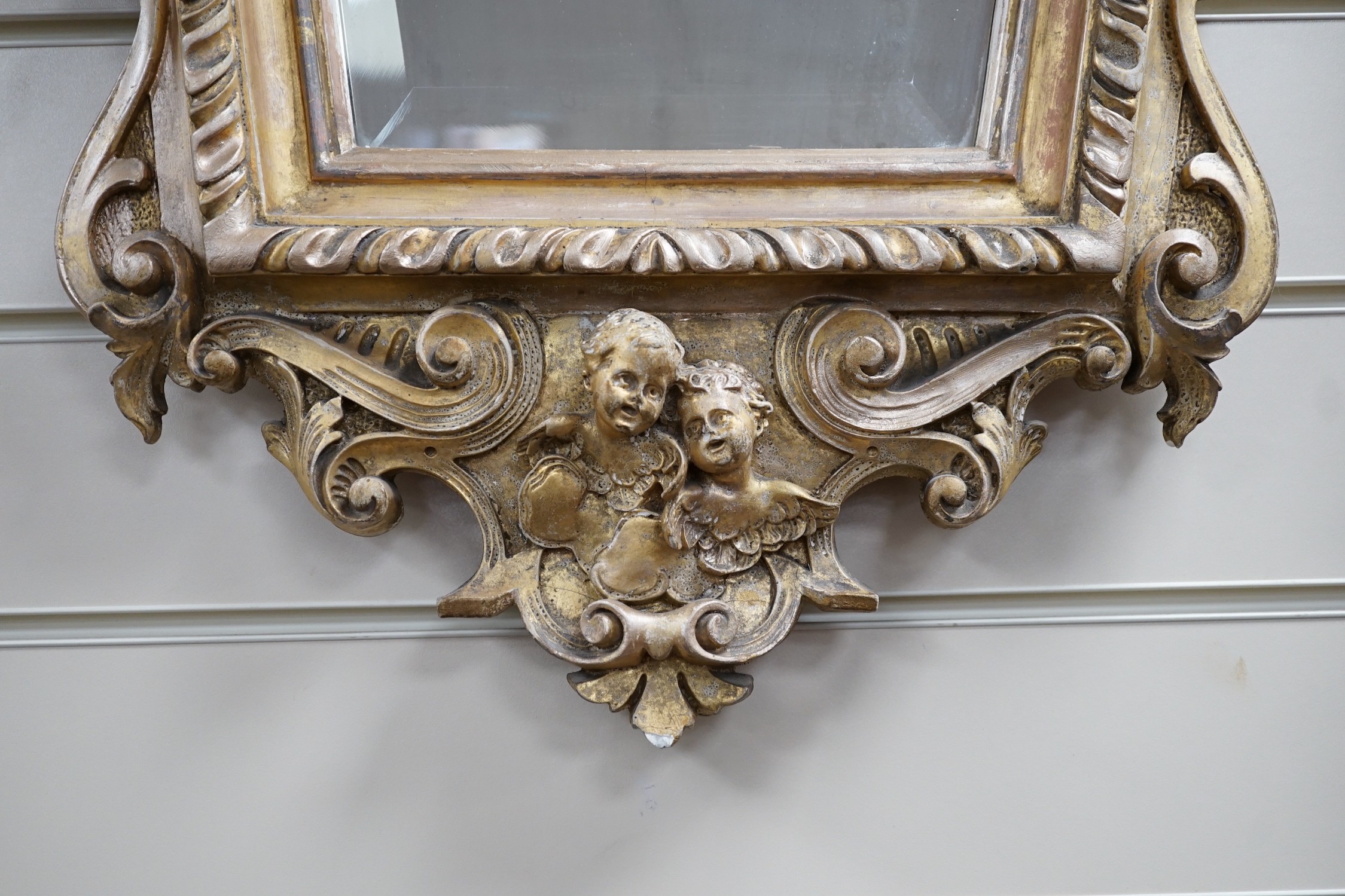 A late 19th century Continental giltwood cartouche shaped wall mirror, width 54cm, height 100cm *Please note the sale commences at 9am.